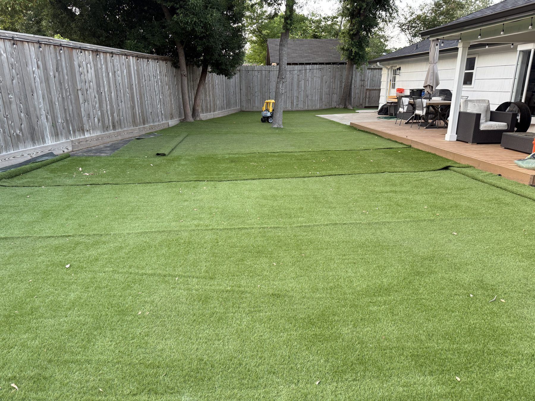 Spacious family turf yard with playhouse — built tough for kids and pets
